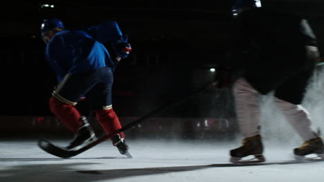 Two-man-playing-hockey-on-ice-rink.-hockey-Two-hockey-players-fighting-for-puck.-STEADICAM-SHOT
